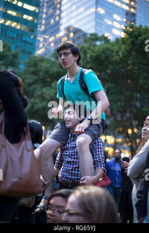 Two young men attend an event in Bryant Park in New York City. Stock Photo