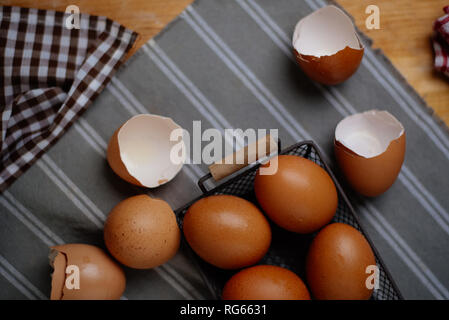 Eggs and eggshells on table Stock Photo