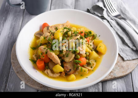 Chicken and Mushroom Fricassee with potato, carrot, green peas, and dill Stock Photo