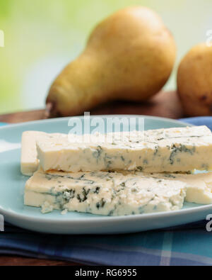 Sliced blue cheese and ripe fresh pears on a rustic table Stock Photo