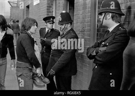 Football fans 1970s UK. Manchester City football fan prevented from entering Queens Park Rangers QPR football ground because he is wearing metal toed working boots. Police said he had to take them off and then was allowed into the football stadium. 1972 UK HOMER SYKES Stock Photo