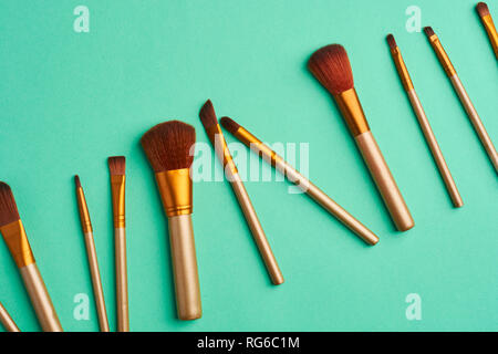 Makeup brushes, everyday make-up tools. Cosmetic essentials on bright background, flat lay Stock Photo