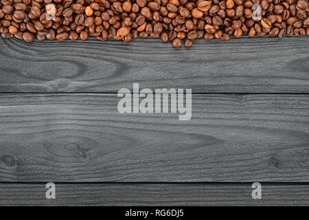 Coffee beans on wooden table top view. Coffee theme template and background with copy space Stock Photo