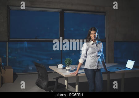 portrait of young female architect on construction site checking documents and business workflow using laptop computer in new startup office Stock Photo