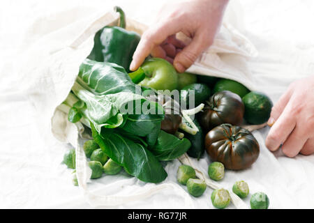 Concept Of Conscious Consumption. Fresh Organic Food Coming Out From Cloth Eco Shopping Bag Stock Photo