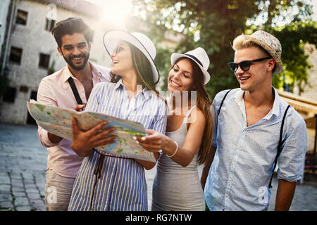 Group of happy friends enjoying sightseeing tour in the city. Stock Photo