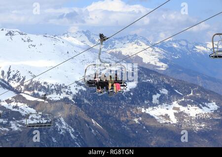 VALLOIRE, FRANCE - MARCH 24, 2015: Skiers go up the lift in Galibier-Thabor station in France. The station is located in Valmeinier and Valloire and h Stock Photo