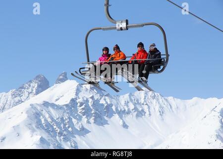 VALLOIRE, FRANCE - MARCH 23, 2015: Skiers go up the lift in Galibier-Thabor station in France. The station is located in Valmeinier and Valloire and h Stock Photo