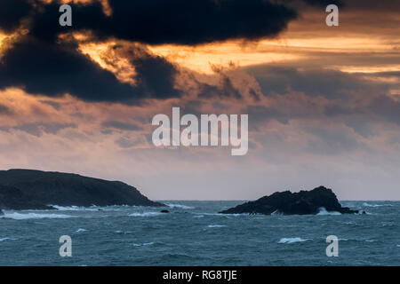 A spectacular sunset over Pentire Point East and Goose Island in Newquay Cornwall. Stock Photo