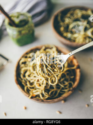 Spaghetti with pesto genovese on spoon, close-up Stock Photo