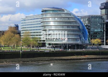 LONDON, UK - APRIL 23, 2016: People walk next to the City Hall (GLA) in London. London is the most populous city and metropolitan area of the European Stock Photo