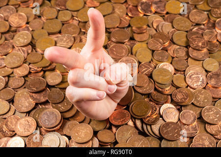 The hand which is sticking out of heap of coins