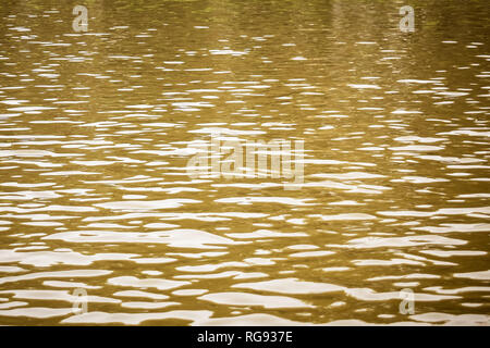 Beautiful pattern of water reflecting the sunlight. Shot of aqua still water surface with ripples and specular highlights. Empty copy space for text. Stock Photo