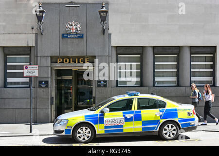 Street scene two blue lights above entrance on exterior of Bishopsgate City of London police station with police patrol car parked outside England UK Stock Photo