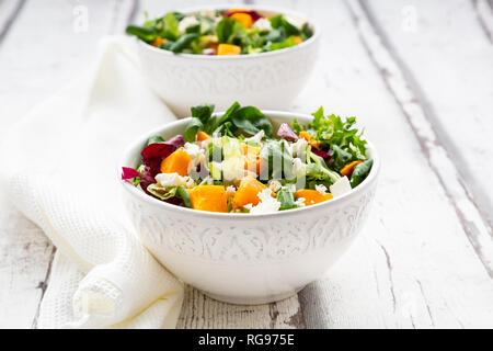 Bowls of autumnal salad with feta and Hokkaido pumpkin Stock Photo