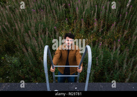 Man climbing up stairs Stock Photo