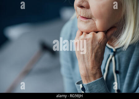 cropped view of senior woman propping chin with hand at home Stock Photo