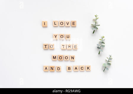 I love you to the moon and back words on white marble background Stock Photo