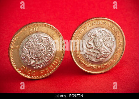 Ten mexican coin on red background. Shot close up Stock Photo