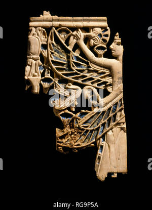 Winged male figure: Nimrud Ivory from Room SW37 Fort Shalmaneser within the Assyrian city of Nimrud, Iraq, photographed in the Iraq Museum, Baghdad. Stock Photo