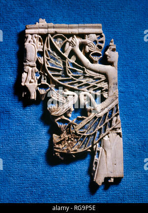 Winged male figure: Nimrud Ivory from Room SW37 Fort Shalmaneser within the Assyrian city of Nimrud, Iraq, photographed in the Iraq Museum, Baghdad. Stock Photo