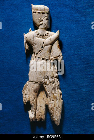 Standing male figure: Nimrud Ivory from Room SW37 Fort Shalmaneser within the Assyrian city of Nimrud, Iraq, photographed in the Iraq Museum, Baghdad. Stock Photo