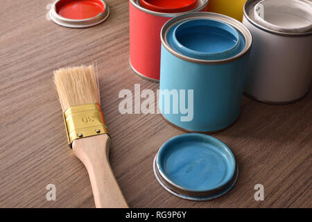Assortment open paint cans and their covers on wooden table. Elevated view. Horizontal composition. Stock Photo