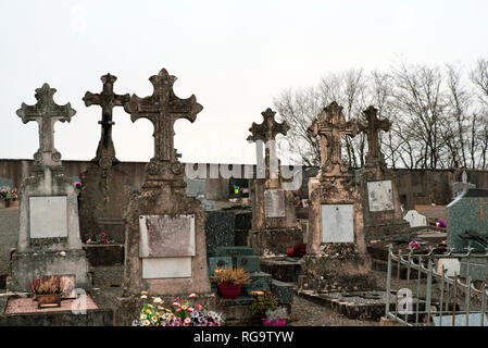 Ancient cross on tombs in a cemetery Stock Photo