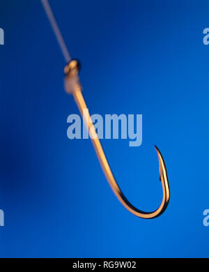 A closeup of a fishhook emphasizing the sharp tip and pointvertical picture Stock Photo