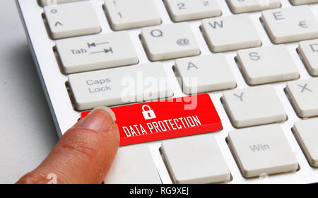 finger on a computer keyboard with Data protection written on it Stock Photo