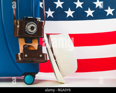 Stylish, blue suitcase, US Flag on a white, isolated background. Close-up. Preparing for the summer trip Stock Photo