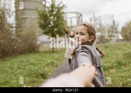 Portrait smiling girl holding hands with mother Stock Photo - Alamy