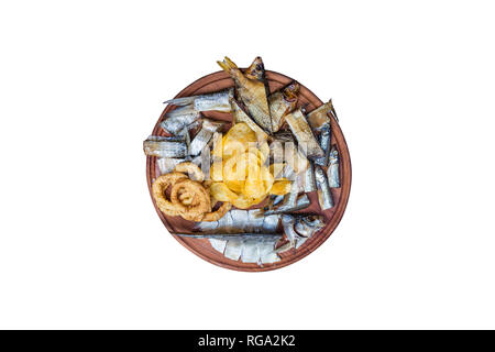 Beer snacks set. Salted, dried fish, squid rings and potato chips,served on the cutting board. Stock Photo