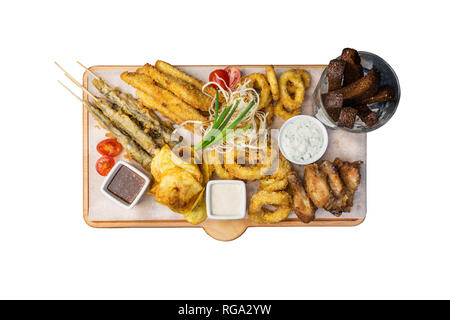 Beer snacks set. Fish set served on cutting board with the mugs, isolated on the white background. Stock Photo