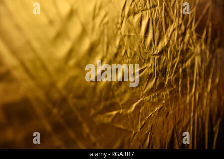 gold dented background. reflector macro. the backdrop for postcards. Stock Photo