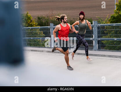 Young couple jogging in the morning Stock Photo