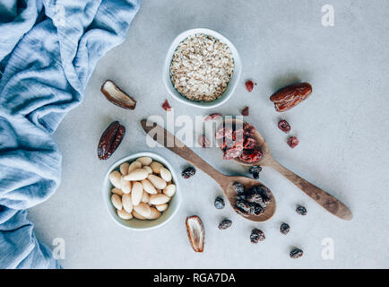 Fruit bar, almonds, raisins, cranberries, oat flakes and dates Stock Photo