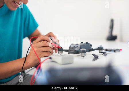 Boy repairing drone Stock Photo