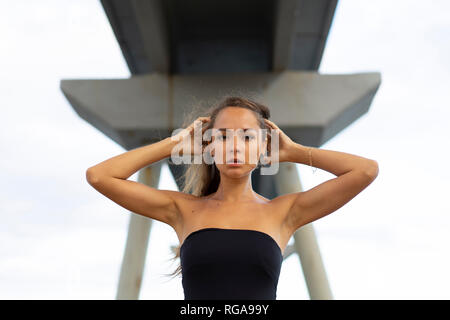 Portrait of beautiful young woman under a bridge Stock Photo