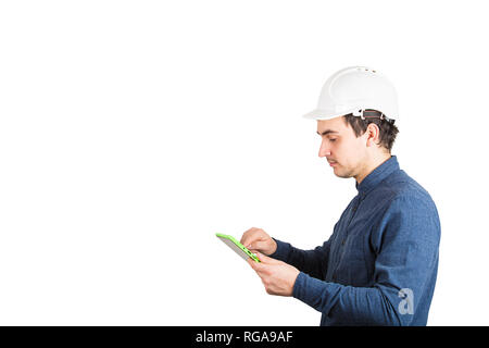 Side view serious of young man engineer wearing protective helmet using a tablet computer gadget to calculate isolated over white background with copy Stock Photo