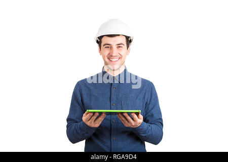 Creative young man engineer wearing protective helmet holding tablet computer as for 3d project plan presentation isolated over white background. Stock Photo