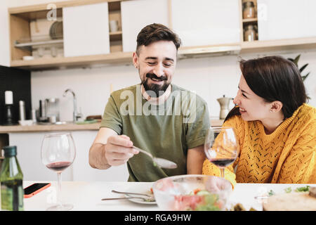 Happy couple in love having lunch together at home Stock Photo