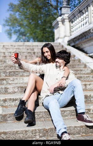 Young couple sitting on outdoor stairs on a autumn day 5043902 Stock Photo  at Vecteezy