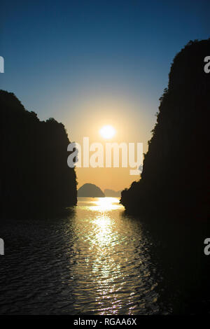 Sunset reflected on sea with silhouette of islands. Stock Photo