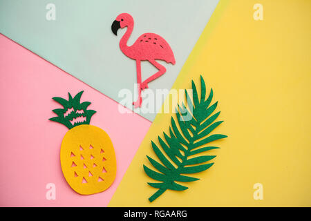 Flamingo, tropical leaf and pineapple on a colored background. Summer background. Stock Photo