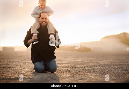 Father and son having fun together on a beach. Stock Photo