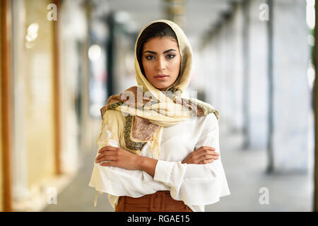 Spain, Granada, young muslim tourist woman wearing hijab in urban city background Stock Photo