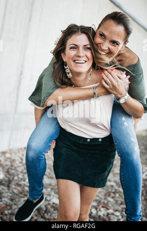 Best friends having fun together, carrying piggyback Stock Photo
