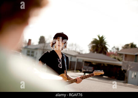 Teenage boy playing the guitar during band practice. Stock Photo