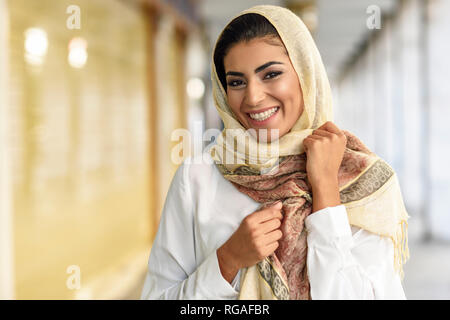 Spain, Granada, young muslim tourist woman wearing hijab during sightseeing in the city Stock Photo